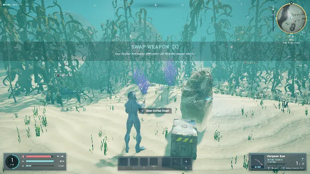 A diver with a harpoon gun near a salvage chest